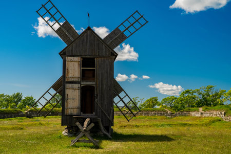 Traditional wooden windmill in countryside.