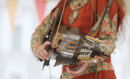 Woman playing nyckelharpa at folk music festival.の写真素材