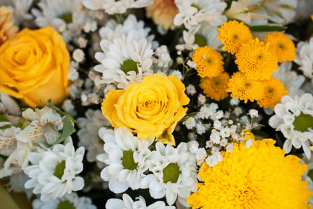 Bright and Cheerful Yellow Floral Arrangement with White Accents.の写真素材