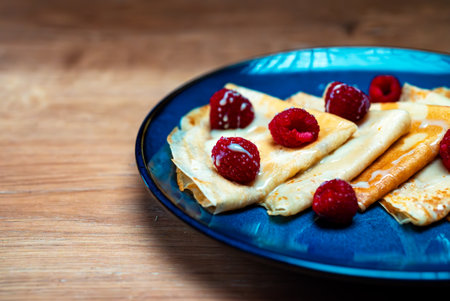Pancakes with raspberries and condensed milk.の写真素材