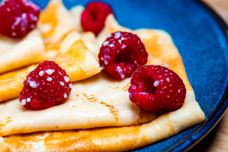 Pancakes with raspberries and condensed milk.