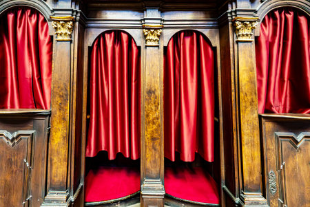 Wooden Confessional Booths with Red Curtains in Church.