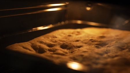 Baking Focaccia Dough in Oven on Metal Tray.の写真素材
