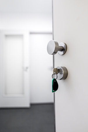 Open door with keys in the lock.の写真素材