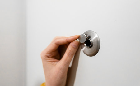 Woman opens the door peephole cover.の写真素材