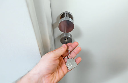 The man opens the door with a key.