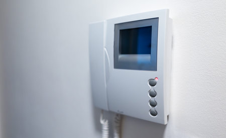 Modern Video Intercom System Mounted on white wall.