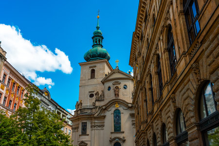 Ancient Saint Gall Church tower among Prague city buildings.の写真素材