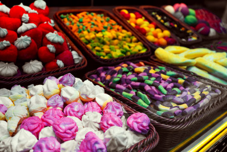Assortment of colorful gummy candies in baskets.の写真素材