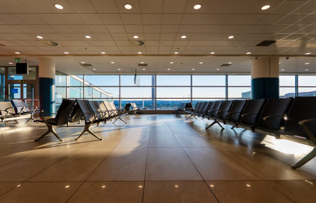 Empty waiting area with seats in a modern international airport terminal.
