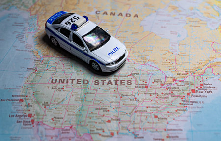 Police car model on map of USA.