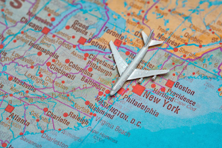 Miniature airplane on map of New York City and East Coast.