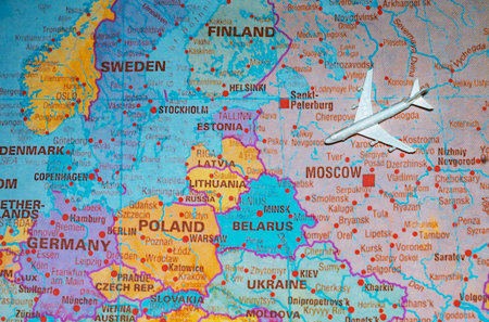 Airplane model on map of Russia flying towards Europe representing reopening of borders.