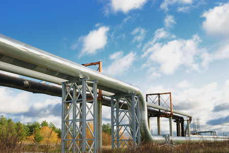 industrial pipelines on pipe-bridge against blue sky.