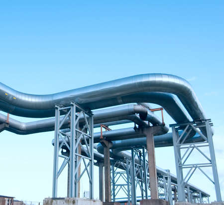 industrial pipelines on pipe-bridge against blue sky.の写真素材