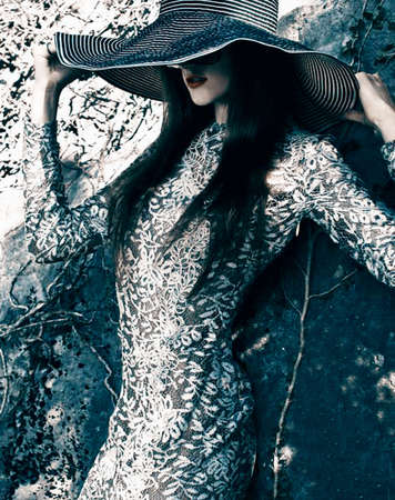 Italian girl in a hat and dress with stonesの写真素材