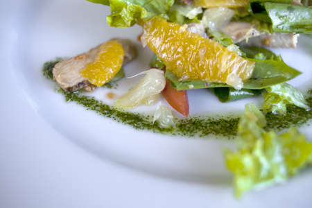 Salad with meat and herbs on a white plateの写真素材