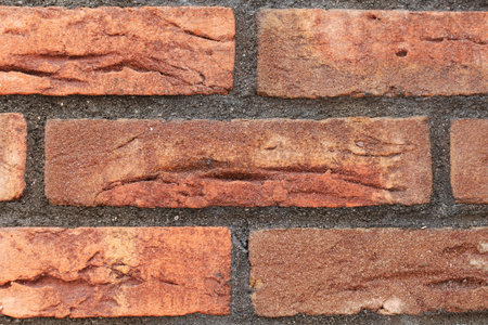 Wall of decorative facing bricks. Abstract background. Clouse up.