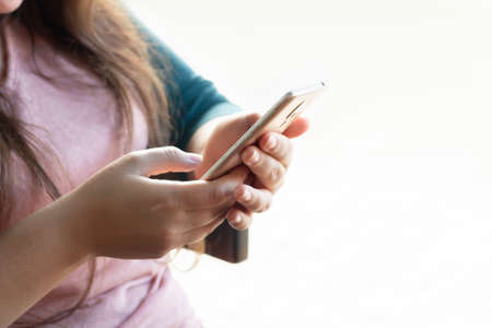 Young woman holding smartphone. Online shopping, communication or business conceptの写真素材