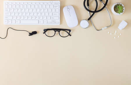 Keyboard, stethoscope, microphone and other supplies top view. Doctor`s online consultation and remote medical communication conceptの写真素材