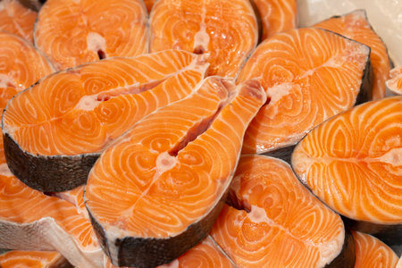Salmon and trout fresh steaks, slices of raw red fish ready ro cooking
