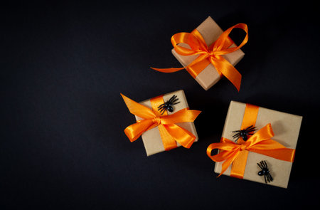Halloween gift boxes with decorative spiders top view on dark background. Space for your textの写真素材