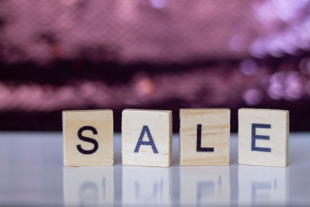 SALE word on wood cubes on pink bokeh backgroundの写真素材
