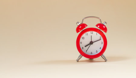 Red vintage alarm clock side view with copy spaceの写真素材