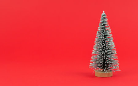 Mini Christmas artificial tree on redの写真素材