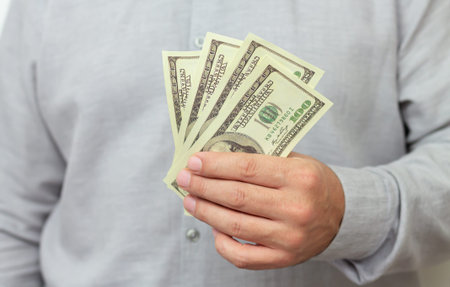 Finance, investment or money saving concept. Man holding paper us dollars