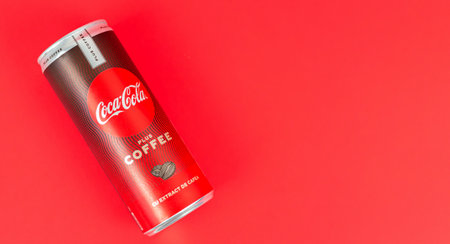 Kiev, Ukraine - December 17, 2020: Can of fizzy Coca-Cola plus coffee extract on red background. Space for textのeditorial素材