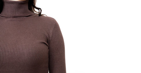 Young woman wearing brown sweater or roll-neck close-up. Banner with copy spaceの写真素材