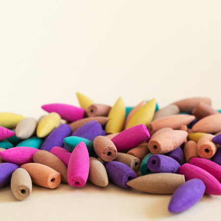 Natural colorful incense cones heap on beigeの写真素材