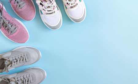 Sport shoes or trainers top view on blue background with copy spaceの写真素材