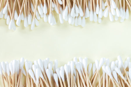 Frame of organic bamboo cotton swabs top view on beige background with copy spaceの写真素材