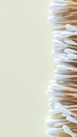 Heap of bamboo cotton swabs or buds top view on beige background, copy space