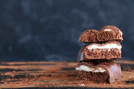 Stack of milk porous or aerated chocolate close-up on dark backgroundの写真素材