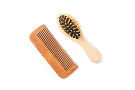 Wooden hair care comb and massage hair brush isolated on white background from aboveの写真素材