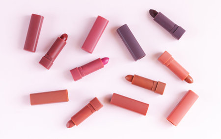 Set of colorful lipsticks on light pink background. Flat lay, top viewの写真素材