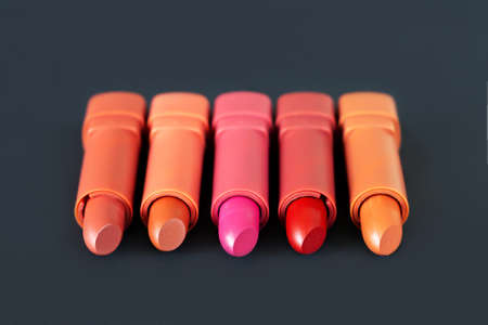 Five different lipsticks on dark background. Cosmetic product conceptの写真素材