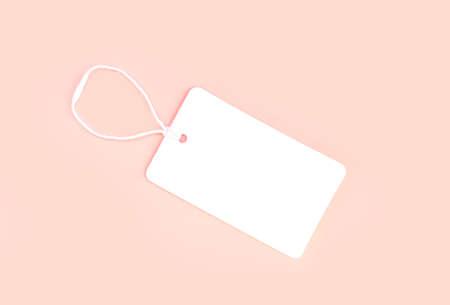 Single blank white paper cloth label or price tag on light pink background top viewの写真素材