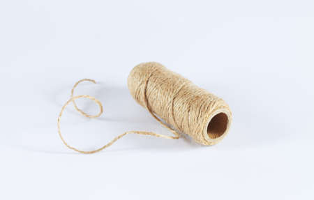 Natural jute twine rope skein isolated on white backgroundの写真素材