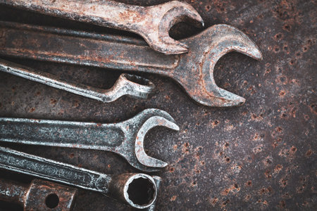 Collection of old wrenches on a rusty metal table. top view