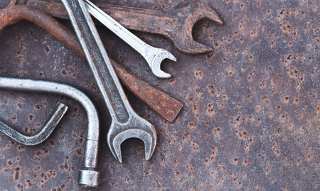 Collection of old garage hand tools on rusty metal table. top view