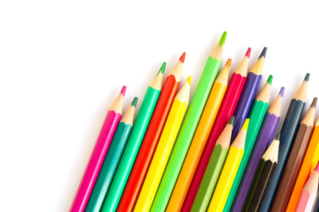 Set of multicolored rainbow pensils isolated on white background. top view