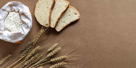 Rural kitchen or bakery background with bag of flour, slices of bread and wheat spikelets. top viewの写真素材