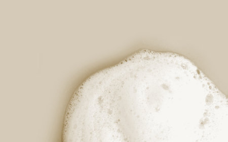 Skin care cleanser mousse foam texture. Soap, shower gel shampoo foam bubbles on beige backgroundの写真素材