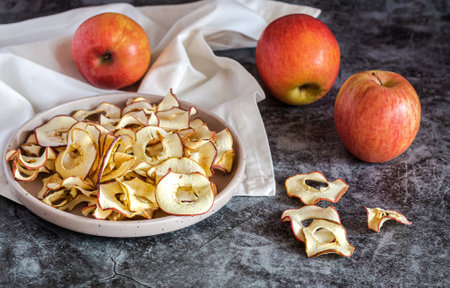 Homemade dried organic apple sliced chips in bowl. Healthy snack conceptの写真素材