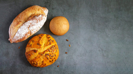 Bakery background with set of different freshly baked crispy bread on kitchen table