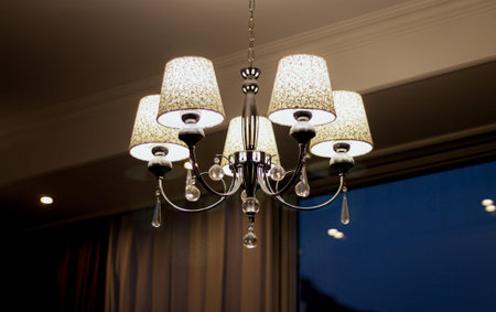 Beautiful classic style chandelier hanging on the hotel room ceilingの写真素材